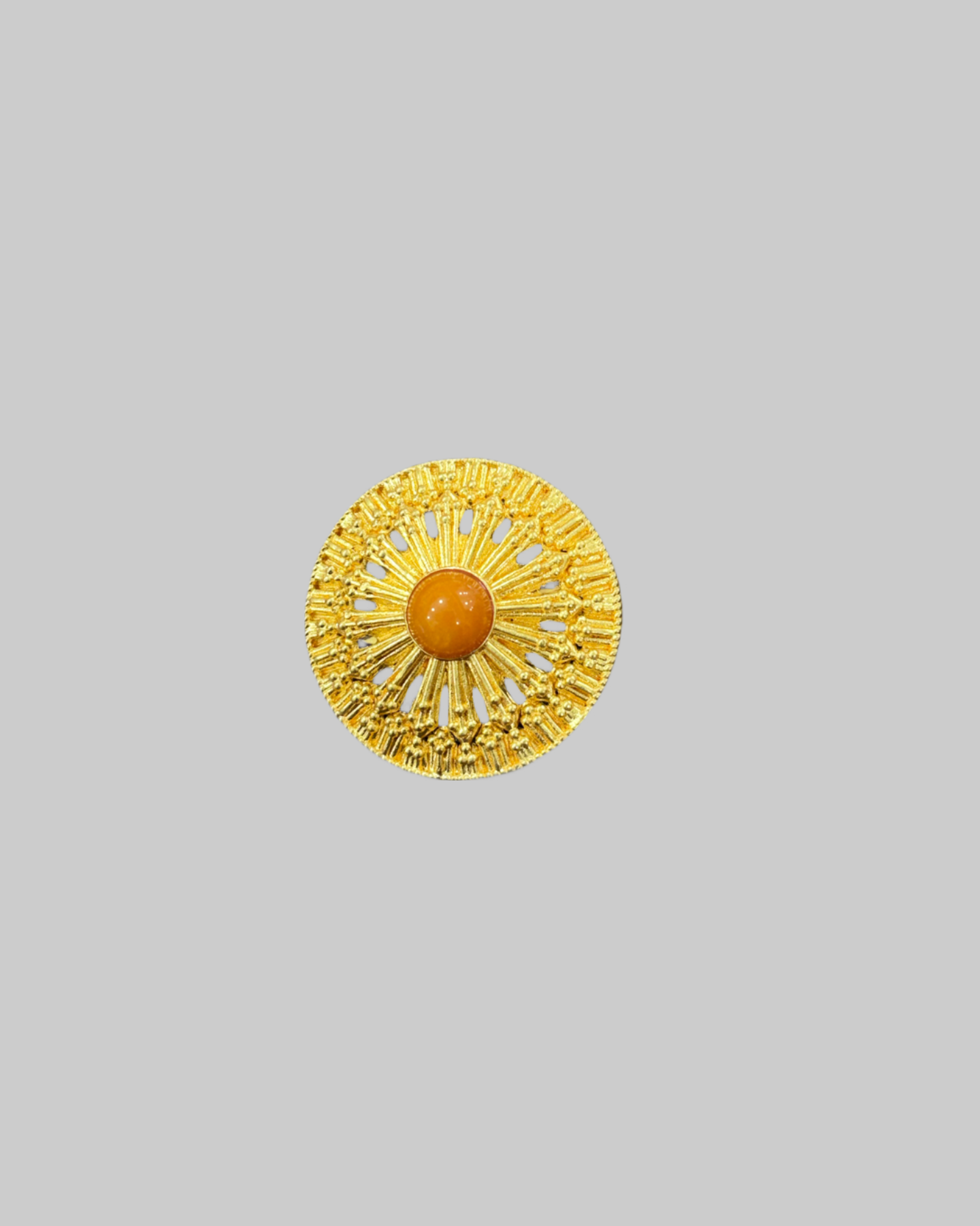 Gold-Tone Sunburst Brooch with Central Orange Glass Crystal front Gold-Tone Sunburst Brooch with Central Orange Glass Crystal - Image 1