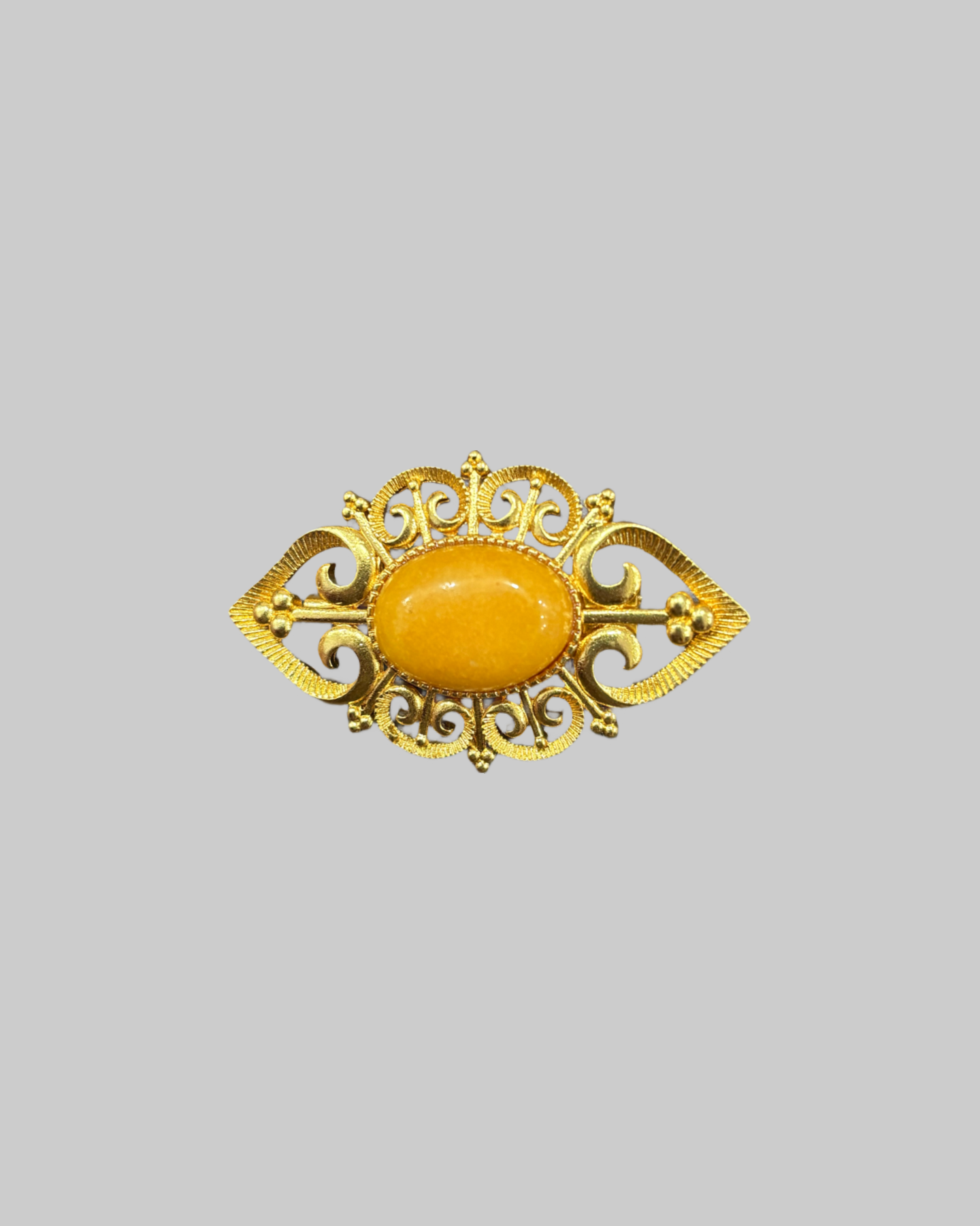 Vintage Gold-Tone Brooch with Large Oval Amber or Amber-Like Gemstone front Vintage Gold-Tone Brooch with Large Oval Amber or Amber-Like Gemstone - Image 1