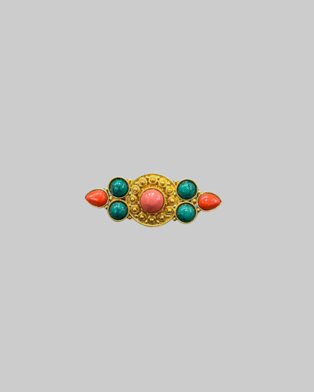 Vintage gold-toned brooch featuring red and green cabochon stones. Vintage gold-toned brooch featuring red and green cabochon stones. - Image 1